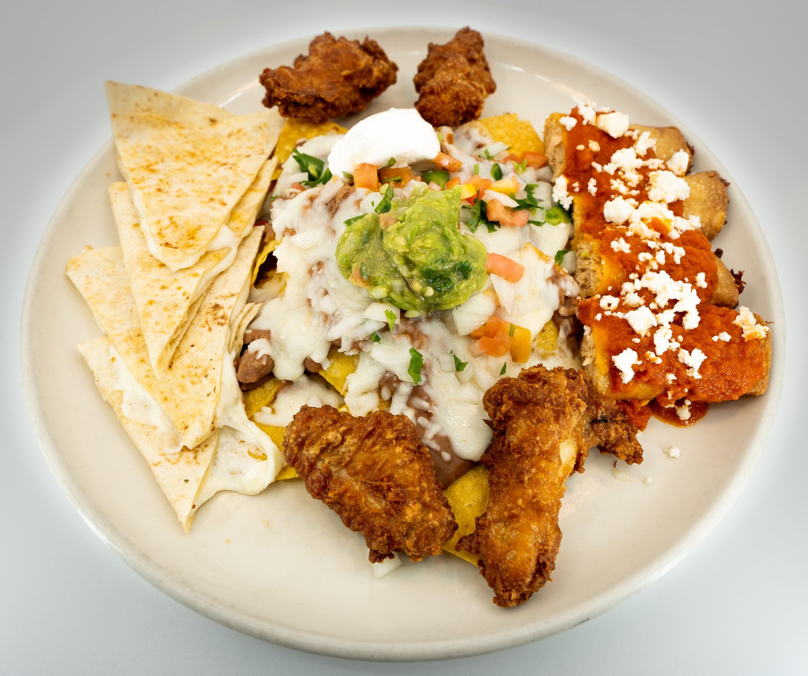 Nachos, wings and taquitos platter