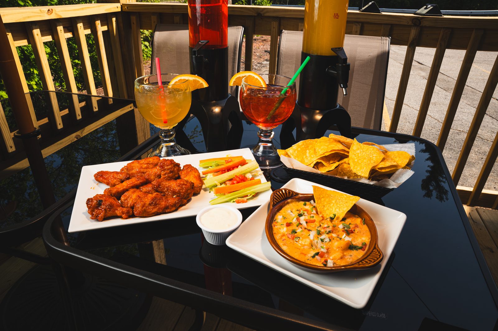 Wings, queso and chips on the patio